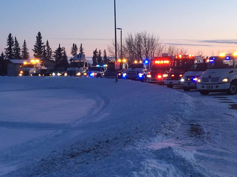 A picture of a bunch of tow trucks with emergency vehicles at a safety rally in Melfort Saskatchewan